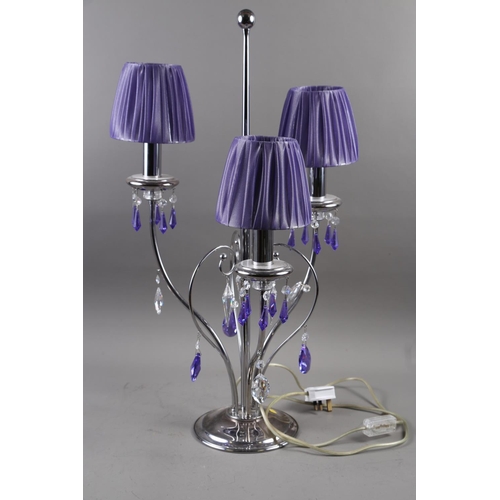 318 - A contemporary three-light table lamp with clear and purple glass spear drops, and a Veritas Supersp... 