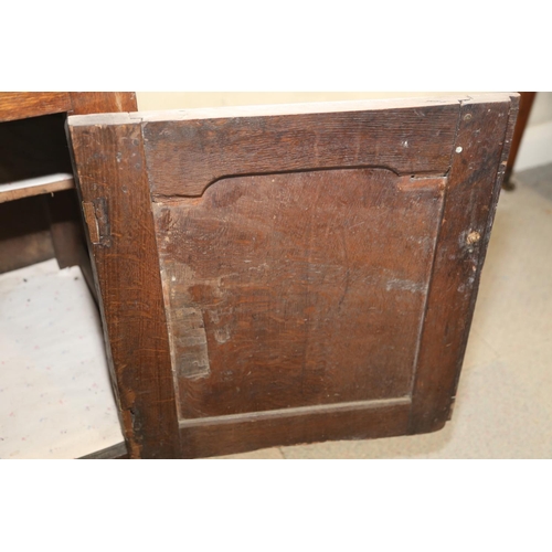 566 - A George III oak dresser, fitted shelves over three drawers and two cupboards enclosed arched panel ... 