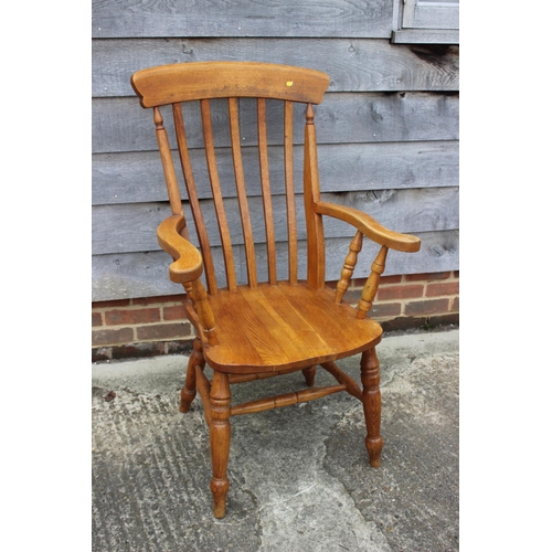 644 - A modern oak Windsor lath back elbow chair