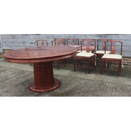 650 - A Chinese hardwood circular dining table, fitted four frieze drawers, on faux bamboo cluster column,... 