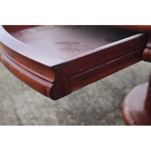 650 - A Chinese hardwood circular dining table, fitted four frieze drawers, on faux bamboo cluster column,... 