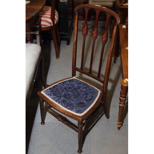 655 - An Edwardian low seat vertical rail back chair and a Sutherland tea table