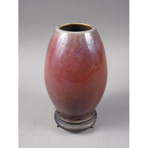 136 - A Chinese flambe glazed barrel-shaped vase, 6 1/2