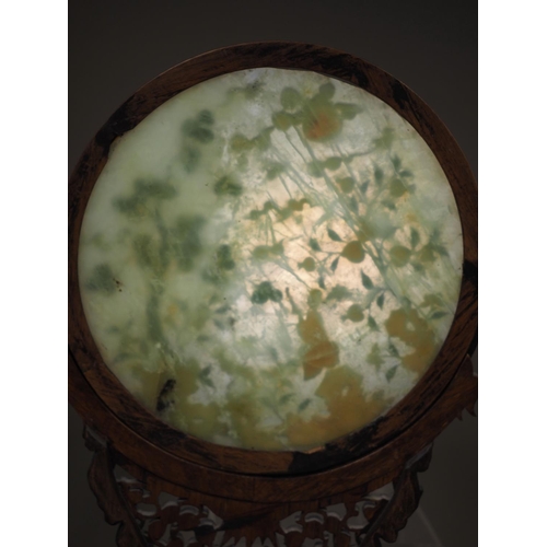 168 - A Chinese circular jade and hardstone inlaid table screen, on carved and pierced stand, 21 1/2