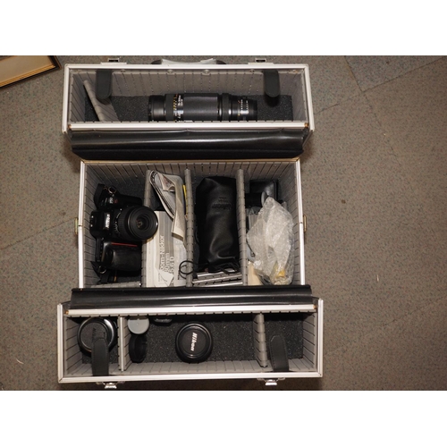 187 - A Nikon F50 camera and a number of additional lenses and accessories, in aluminium case