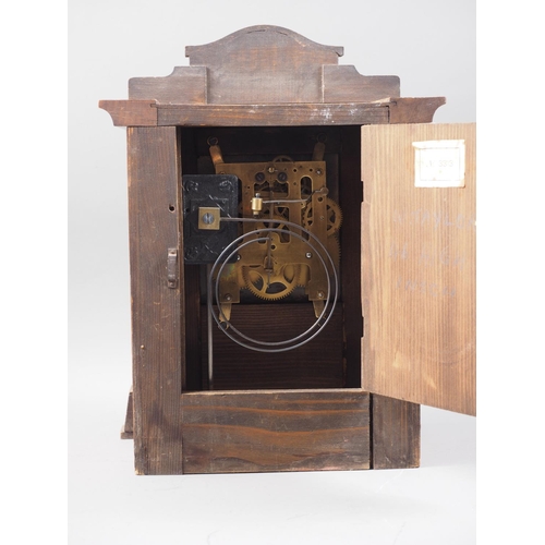 190 - An oak cased mantel clock with brass and white enamelled dial and Roman numerals, 13 1/2