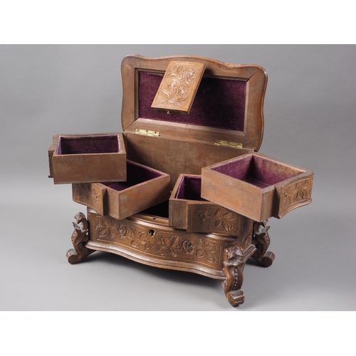 223 - A carved Black Forest jewellery box, the lid carved with two birds and a nest with eggs