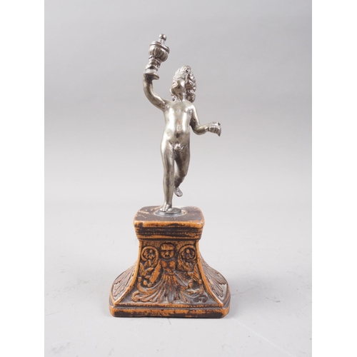 294 - A cast white metal figure of a putto holding a covered goblet, on Florentine carved hardwood stand, ... 