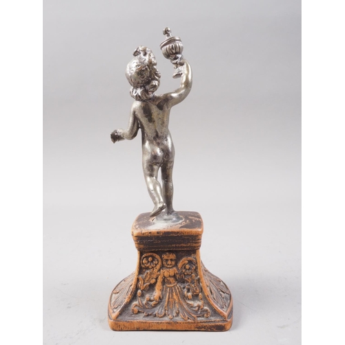 294 - A cast white metal figure of a putto holding a covered goblet, on Florentine carved hardwood stand, ... 