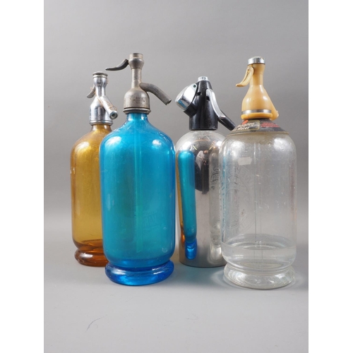 298 - A blue glass soda siphon, an amber glass soda siphon and two other soda siphons