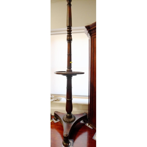 327 - A mahogany standard lamp with rotating centre, on triform base and turned supports