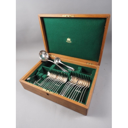 344 - An oak part canteen of Mappin and Webb silver plated cutlery