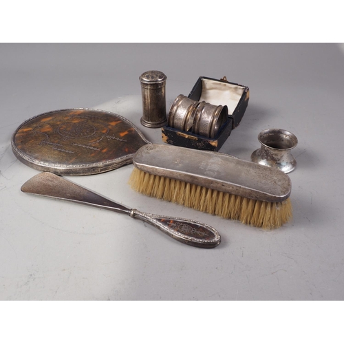 365 - A tortoiseshell and silver mounted hand mirror, a matching shoe horn, a silver backed brush, a peppe... 