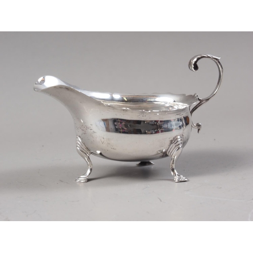 371 - A silver sauce boat with scrolled handle, 3.2oz troy approx