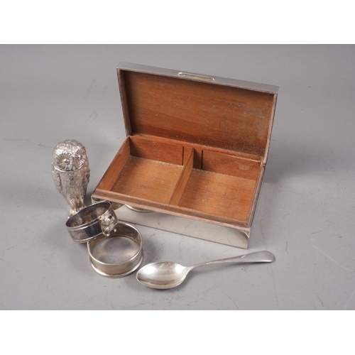 385 - An engine turned cigarette box, two silver napkin rings, a silver teaspoon and a silver plated box, ... 