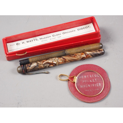 397 - Two early 20th century fountain pens and a pocket magnifier, in leather case