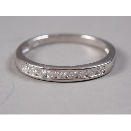 400 - A white metal and diamond half eternity ring, stamped Plat, size Q