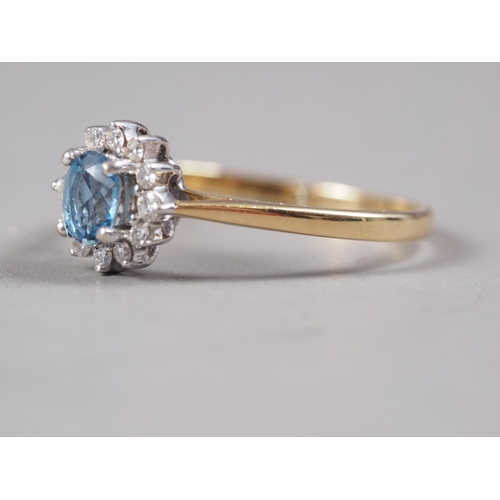 402 - An 18ct gold aquamarine and diamond cluster ring, size P