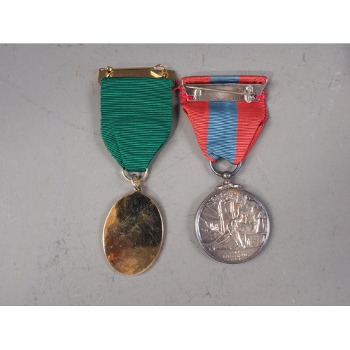 433 - A British Imperial Service Medal, in fitted box, and a commemorative medal