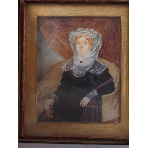 525 - An early 19th century portrait miniature, watercolour of a seated woman dressed in black, 4 1/4