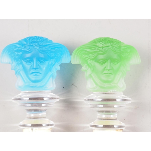 56 - Two Rosenthal for Versace bottle stoppers, formed as the bust of Medusa, one green and one blue