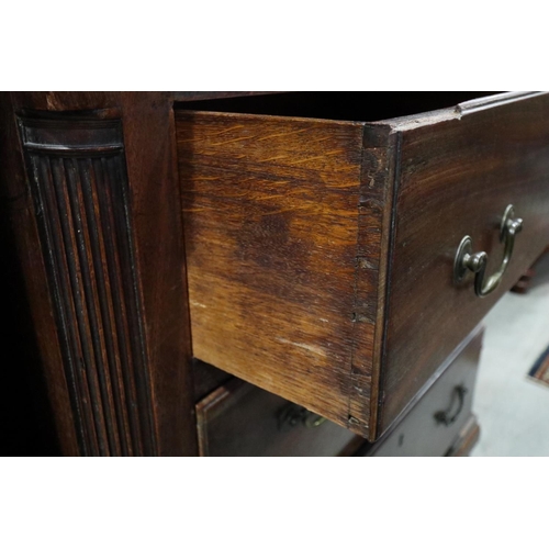 602 - A bachelor's Georgian mahogany chest with fluted columns, fitted slide over three long graduated dra... 