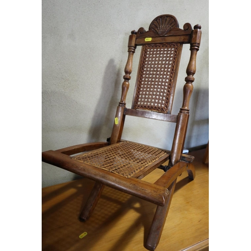 610 - A child's Victorian polished as walnut folding chair with cane seat and back panels