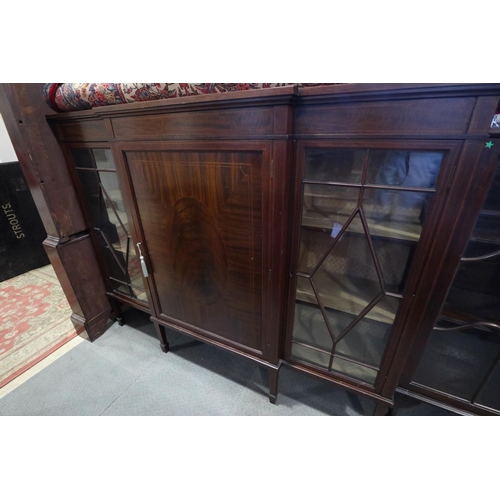 679 - A 1930s breakfront display cabinet with centre panel door and two lattice glazed doors, on square ta... 