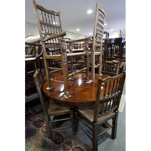 717 - A set of six oak spindle back dining chairs with rush envelope seats, on turned and stretchered supp... 