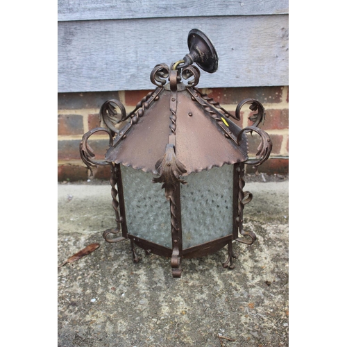 328 - A wrought iron hexagonal ceiling lantern with acanthus leaf finials and engraved floral pattern glas... 