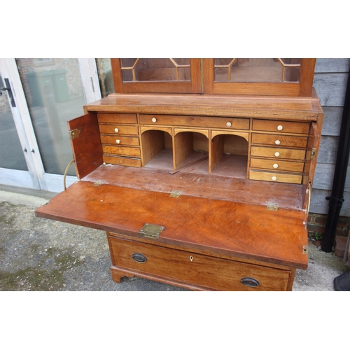 580 - A 19th century walnut and burr yew inlaid secretaire bookcase, the upper section enclosed two astrag... 