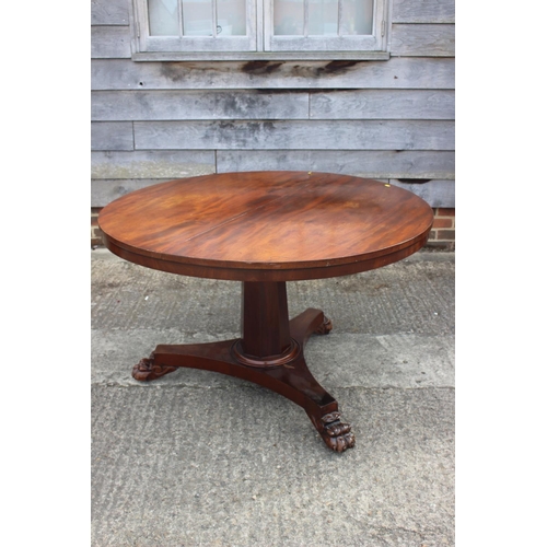 581 - A 19th century mahogany circular dining table, on faceted column triform base with lion paw feet, 47... 