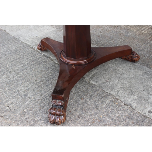 581 - A 19th century mahogany circular dining table, on faceted column triform base with lion paw feet, 47... 