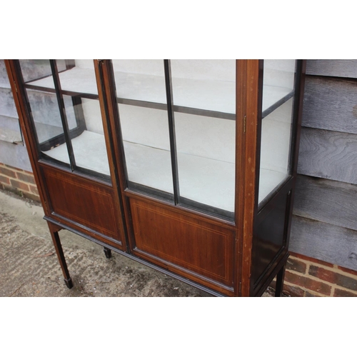 583 - A late 19th century walnut and line inlaid display cabinet enclosed Gothic lattice glazed doors, on ... 