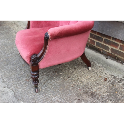 584 - A Victorian mahogany showframe armchair, button upholstered in a pink Dralon, on turned supports