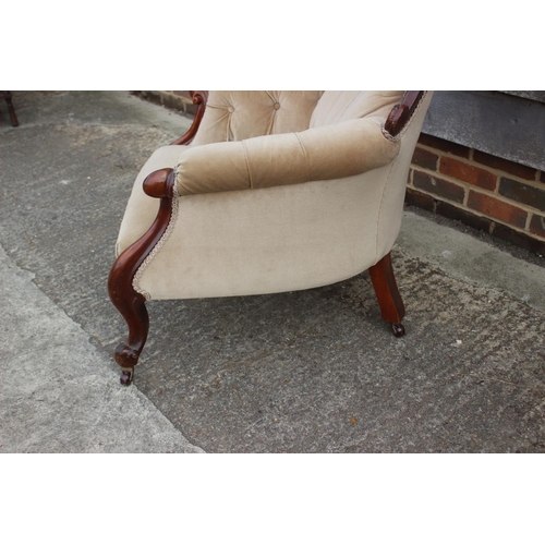 585 - A Victorian walnut showframe armchair, upholstered in a mushroom velour, on cabriole supports