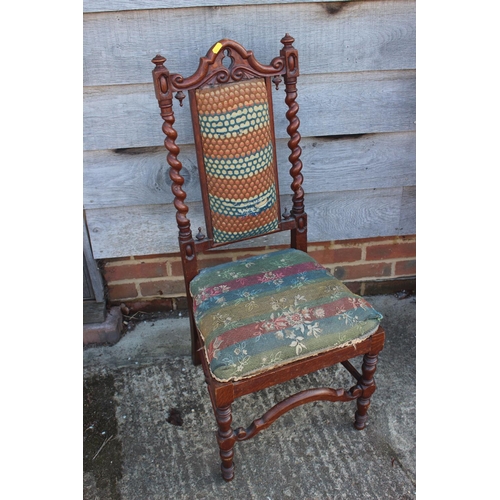 606 - A late 19th century carved oak side chair of 17th century design with padded seat and back, on barle... 