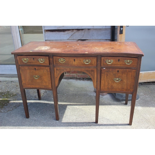 607 - A mahogany and banded serpentine front sideboard, fitted three drawers over two cupboards, on square... 