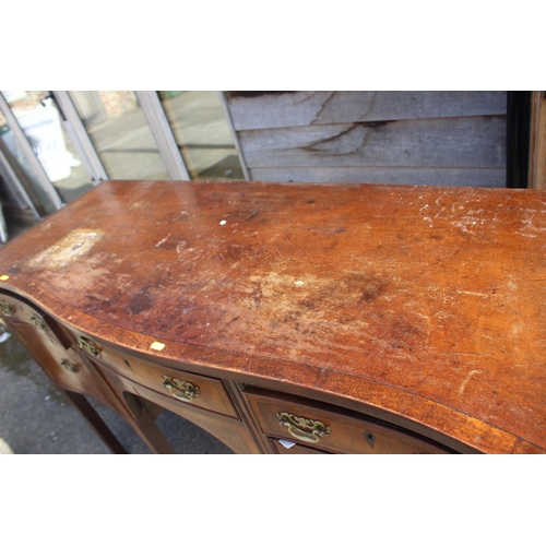 607 - A mahogany and banded serpentine front sideboard, fitted three drawers over two cupboards, on square... 