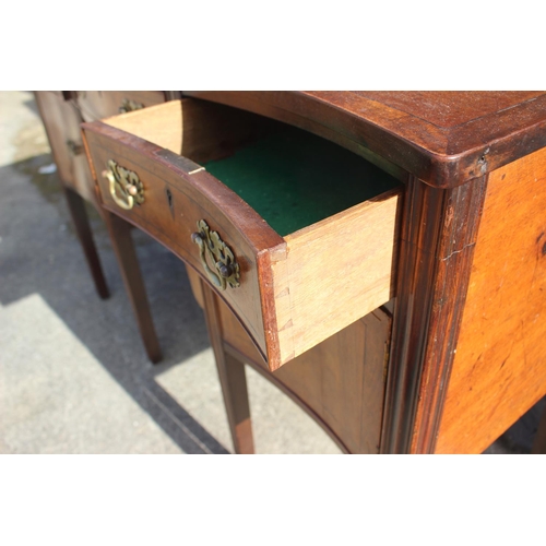 607 - A mahogany and banded serpentine front sideboard, fitted three drawers over two cupboards, on square... 