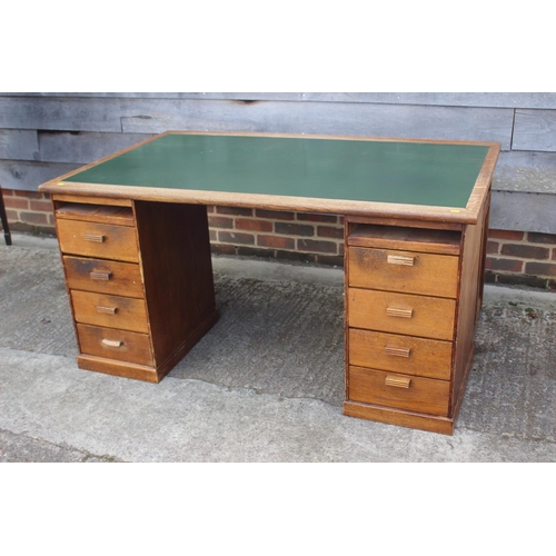 640 - A 1920s oak desk, fitted eight drawers and green leatherette top, 58