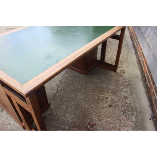 640 - A 1920s oak desk, fitted eight drawers and green leatherette top, 58