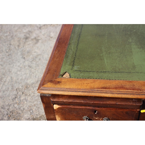 641 - A partners early 20th century walnut double pedestal desk with green leather top (for restoration), ... 