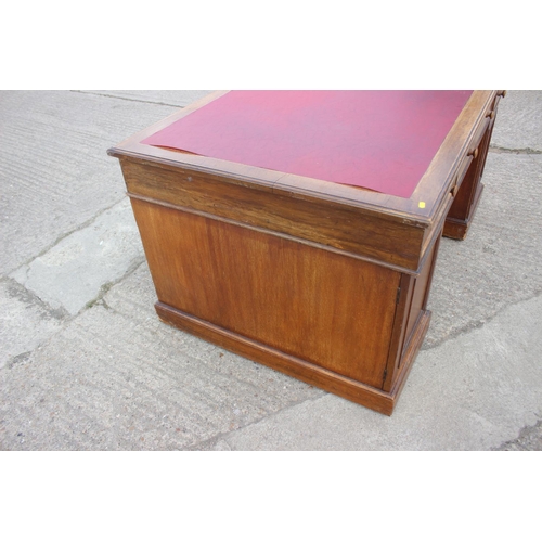 642 - A partners early 20th century mahogany double pedestal desk with red leatherette top, fitted two dra... 