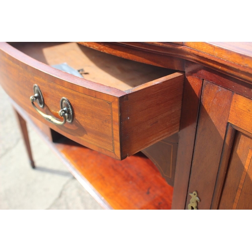 658 - A mahogany and banded break bowfront sideboard, fitted one drawer and two cupboards enclosed panelle... 