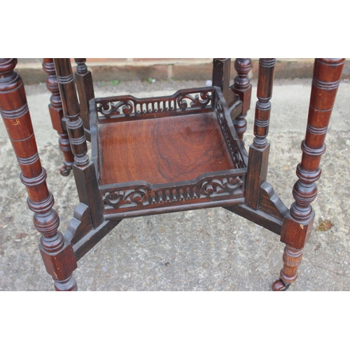 660 - An Edwardian rosewood and inlaid octagonal two-tier occasional table, on turned and castored support... 