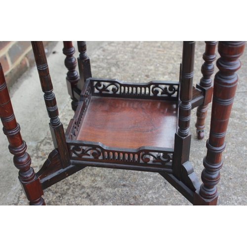 660 - An Edwardian rosewood and inlaid octagonal two-tier occasional table, on turned and castored support... 