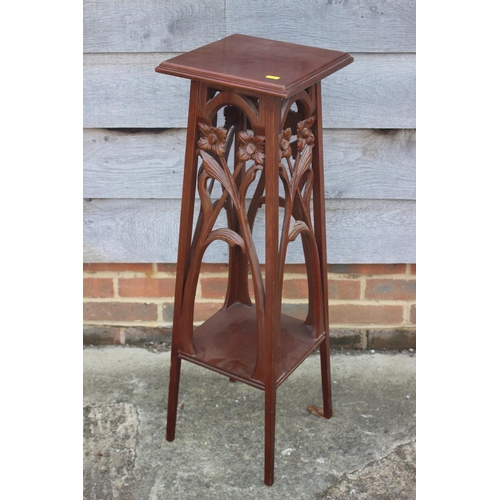 661 - An early 20th century carved mahogany jardiniere stand with floral panels, 11