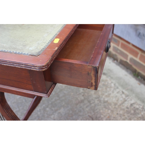 665 - A mahogany writing desk of Georgian design with green tooled leather lined top, fitted two drawers, ... 