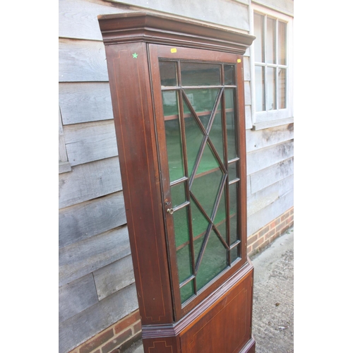 691 - A mahogany two-section corner display cabinet, the upper section enclosed astragal glazed door over ... 